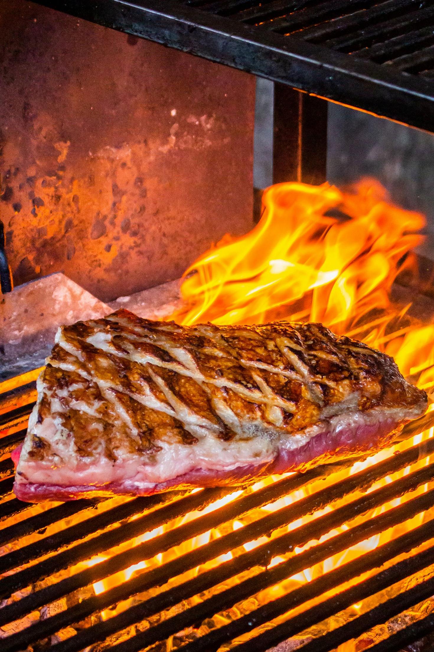 Sizzling steak on grill