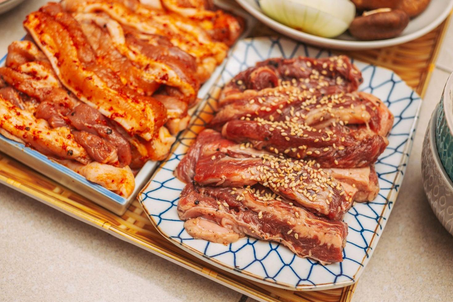 BBQ ingredients and marinated meats overhead